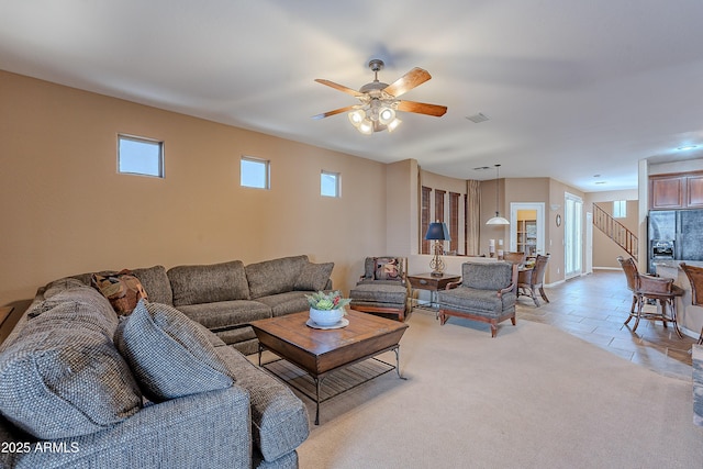 living room featuring light tile patterned floors and ceiling fan