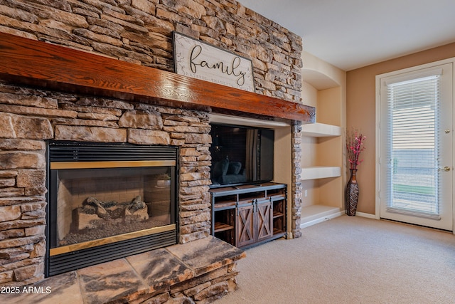 details with carpet flooring, built in shelves, and a fireplace