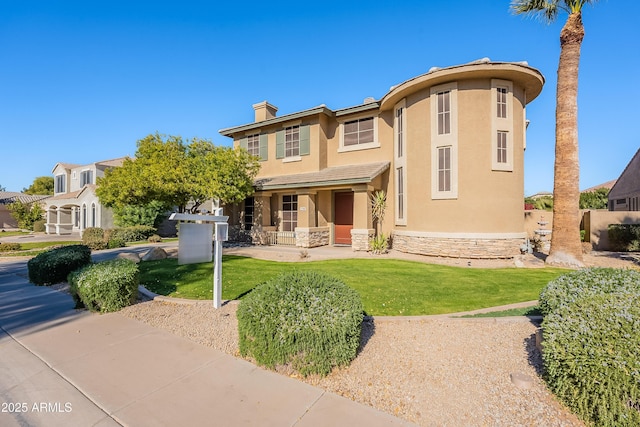 view of front of property featuring a front yard and covered porch