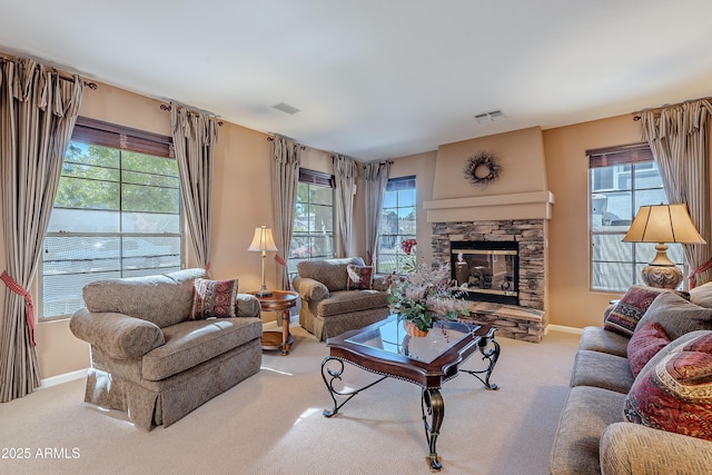 carpeted living room featuring a fireplace