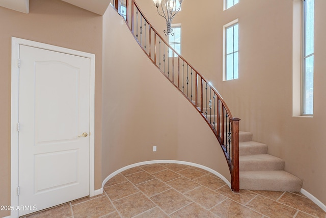 stairway featuring an inviting chandelier