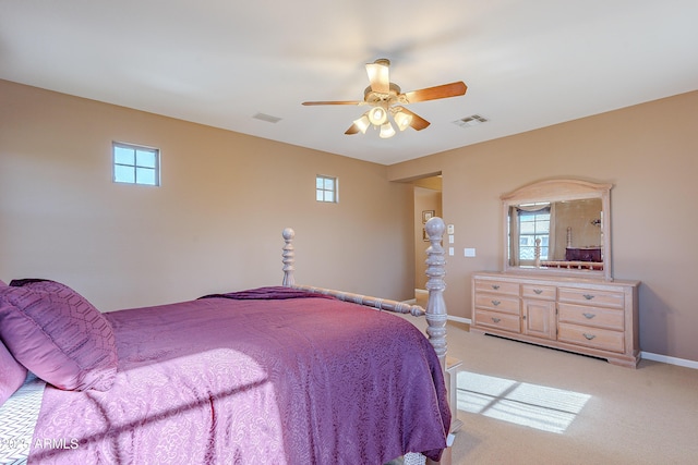 bedroom with ceiling fan and light carpet