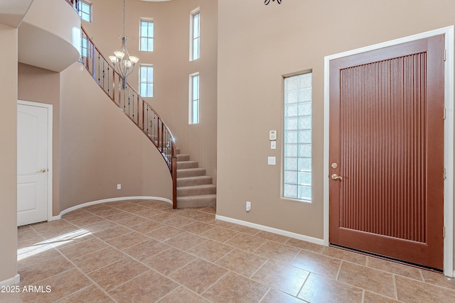 foyer entrance with a high ceiling and an inviting chandelier