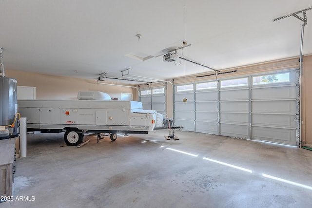 garage featuring gas water heater and a garage door opener