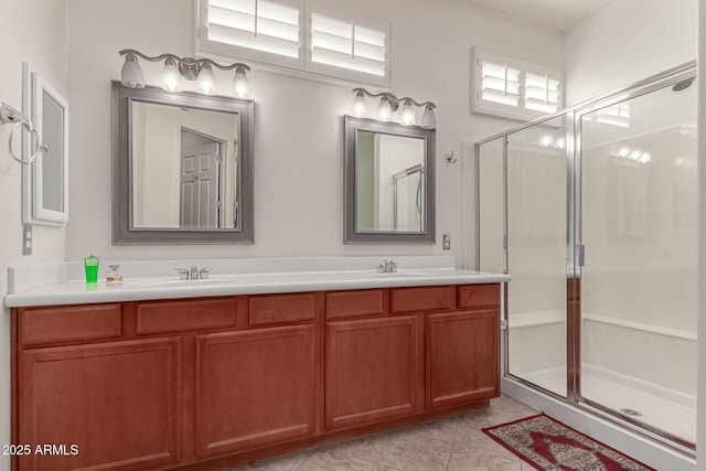 bathroom with tile patterned flooring, vanity, and a shower with shower door