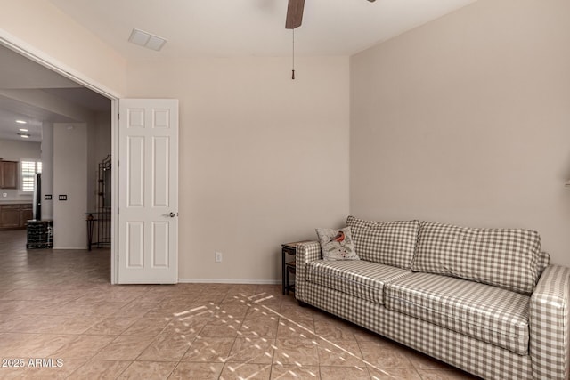 tiled living room with ceiling fan