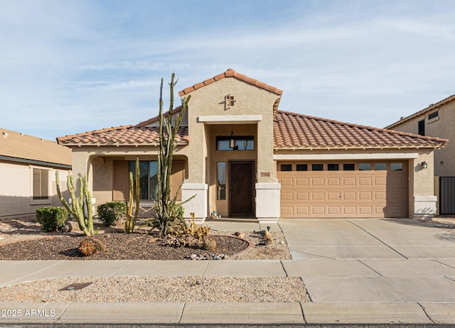 view of front facade with a garage, driveway, a tiled roof, and stucco siding