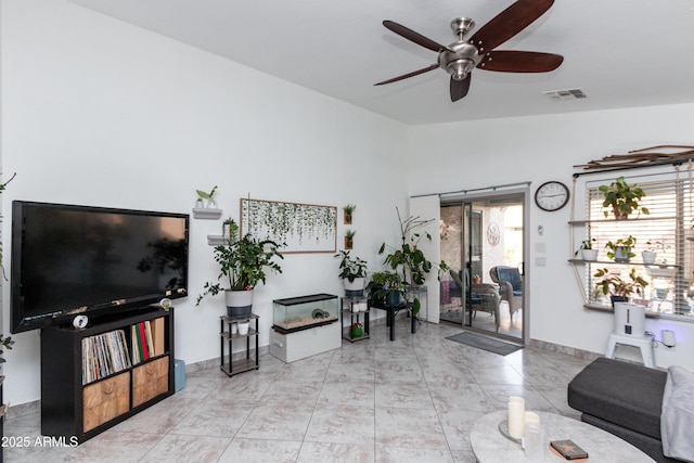 living room with lofted ceiling, plenty of natural light, visible vents, and ceiling fan