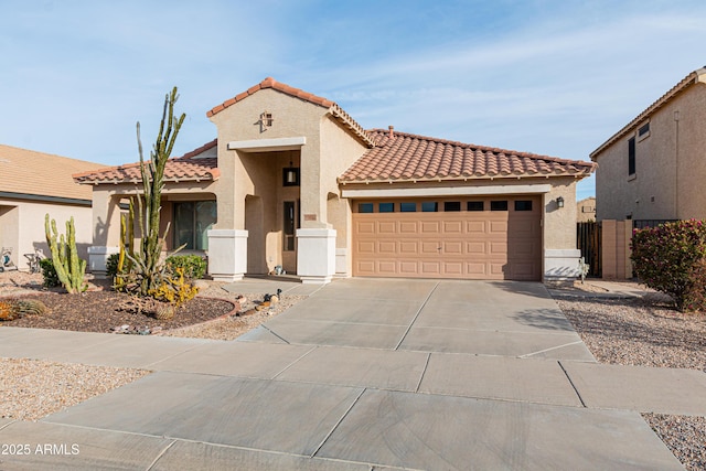 mediterranean / spanish-style house with a garage, driveway, a tile roof, fence, and stucco siding