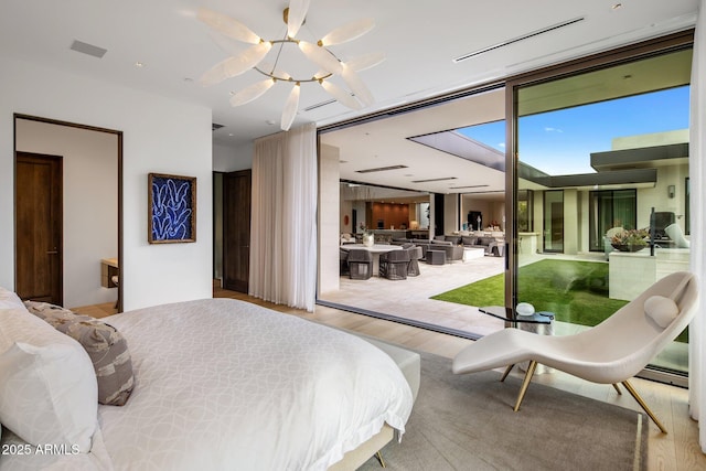 bedroom featuring access to outside and light wood-type flooring