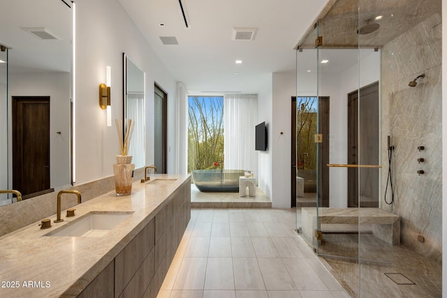 bathroom featuring vanity, tile patterned flooring, and plus walk in shower