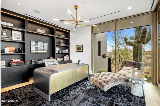 bedroom featuring dark hardwood / wood-style floors, expansive windows, and a chandelier