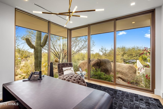 sunroom / solarium featuring a notable chandelier and a wealth of natural light