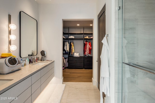 bathroom featuring an enclosed shower, vanity, and tile patterned floors