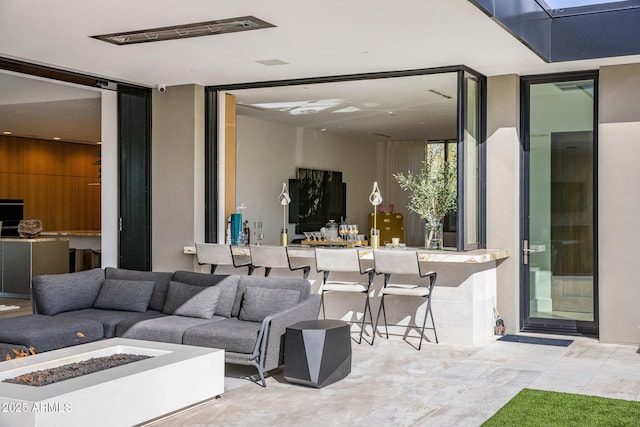 view of patio / terrace with an outdoor bar and an outdoor fire pit