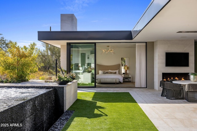 view of patio / terrace featuring an outdoor fireplace