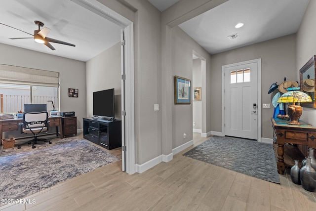 foyer entrance with light hardwood / wood-style floors and ceiling fan