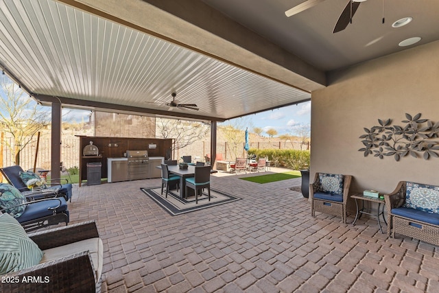 view of patio featuring ceiling fan, an outdoor kitchen, and area for grilling