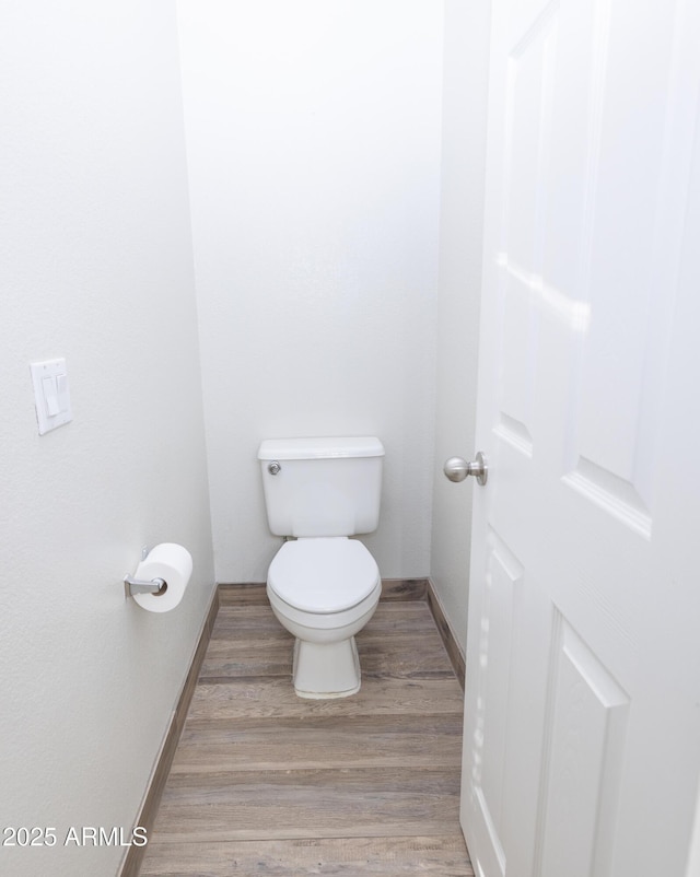 bathroom with wood-type flooring and toilet