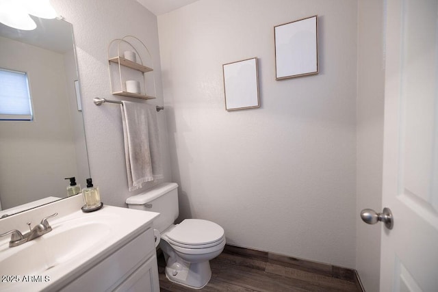 bathroom with vanity, wood-type flooring, and toilet