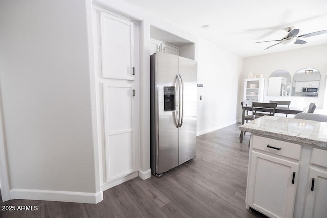 kitchen featuring white cabinetry, appliances with stainless steel finishes, light stone countertops, and wood-type flooring