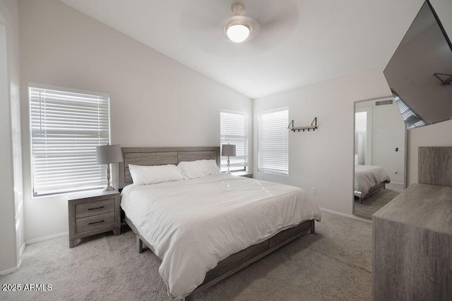 bedroom featuring ceiling fan, light colored carpet, and vaulted ceiling