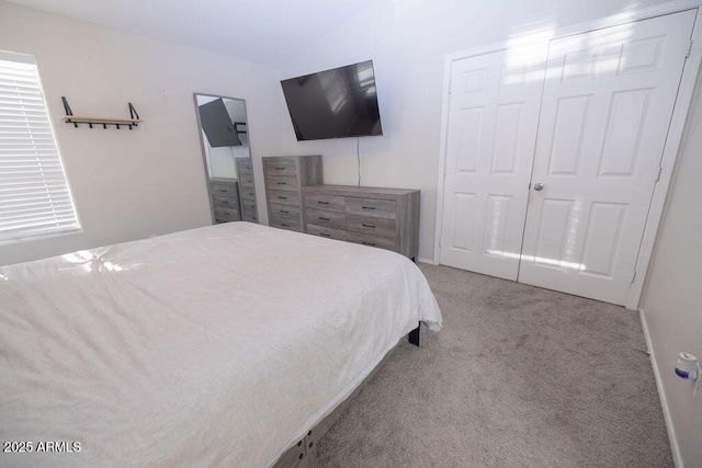 carpeted bedroom featuring lofted ceiling