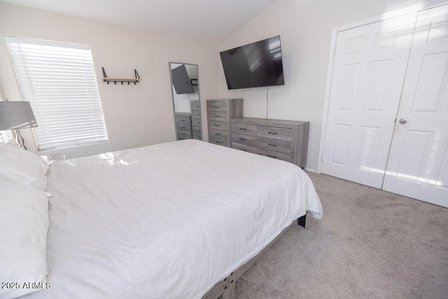 carpeted bedroom with vaulted ceiling