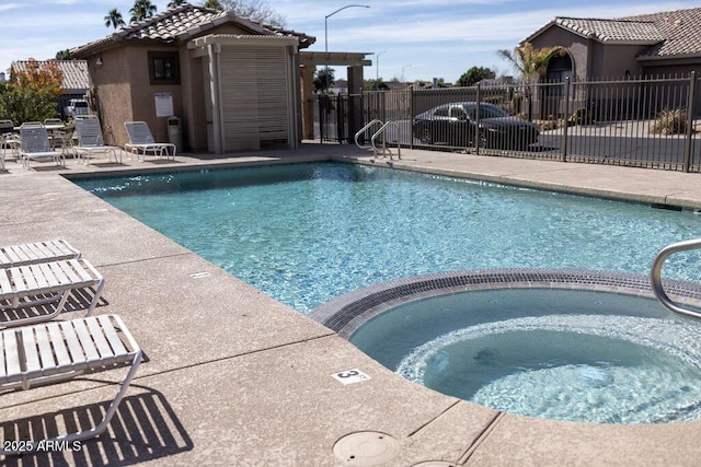 view of swimming pool with a community hot tub