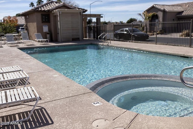 view of swimming pool featuring a community hot tub and a patio