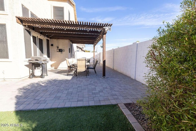 view of patio with a grill and a pergola