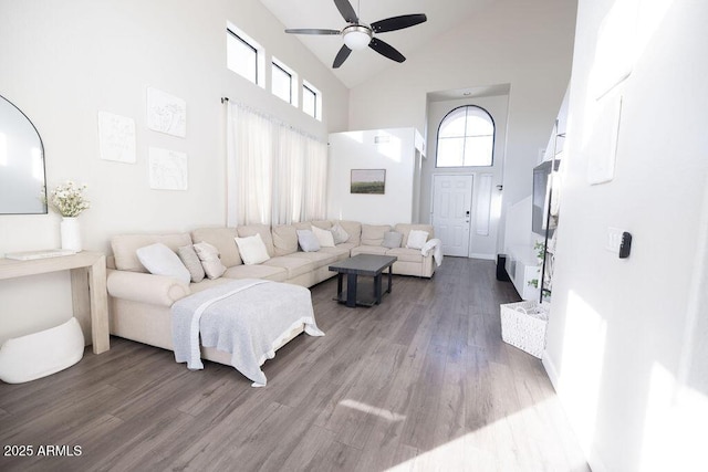 living room with ceiling fan, wood-type flooring, and high vaulted ceiling