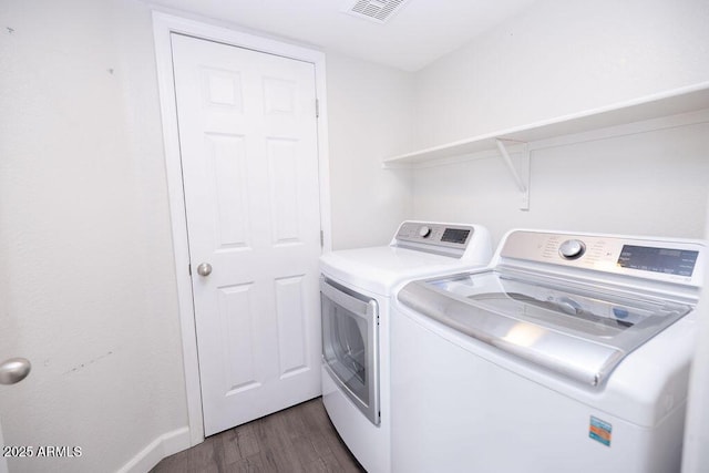 laundry room featuring separate washer and dryer and dark wood-type flooring