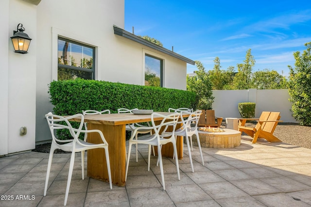 view of patio / terrace with fence and a fire pit