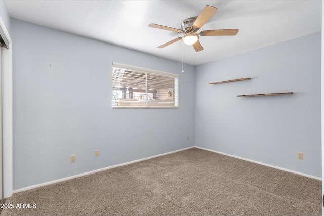 unfurnished room featuring ceiling fan and carpet floors