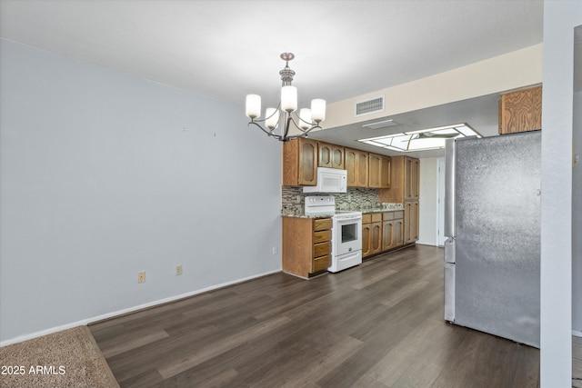 kitchen featuring pendant lighting, white appliances, dark wood-type flooring, decorative backsplash, and a chandelier