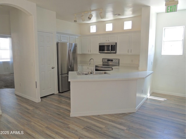 9233 E Neville Ave Unit 1011, Mesa, AZ 85209 - kitchen featuring appliances with stainless steel finishes, a peninsula, rail lighting, and dark wood finished floors