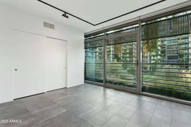 unfurnished room with floor to ceiling windows