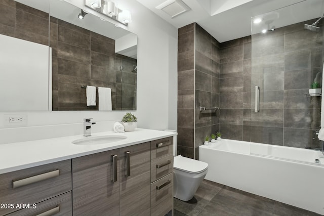 full bathroom featuring vanity, toilet, and tiled shower / bath combo