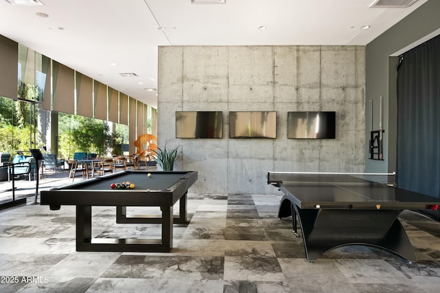 recreation room with a wall of windows and billiards