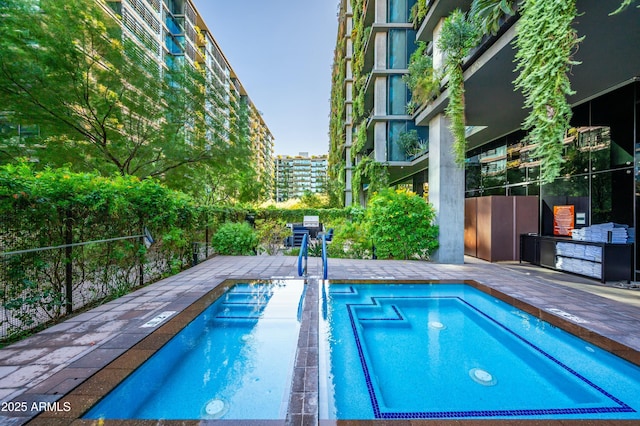 view of swimming pool with a patio area