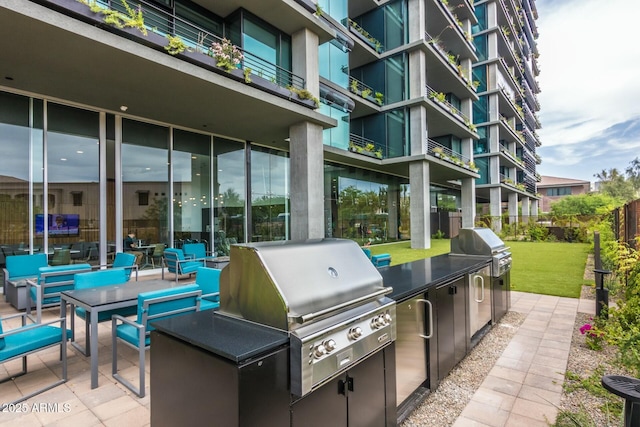 view of patio / terrace with exterior kitchen and a grill