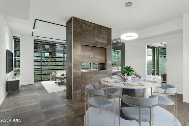 dining room with a tile fireplace