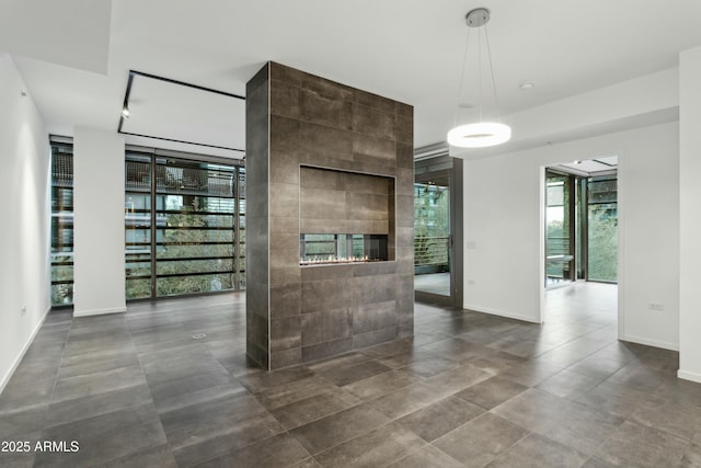 interior space with a multi sided fireplace and floor to ceiling windows