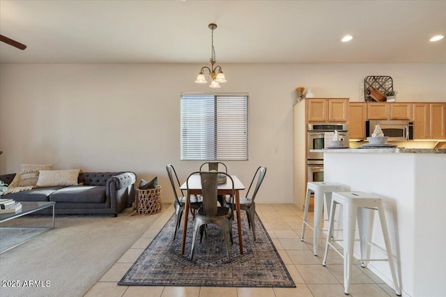 tiled dining area with an inviting chandelier