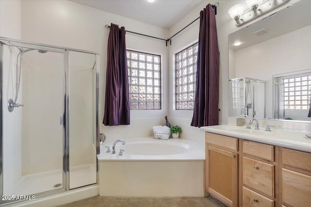 bathroom with separate shower and tub, vanity, and plenty of natural light