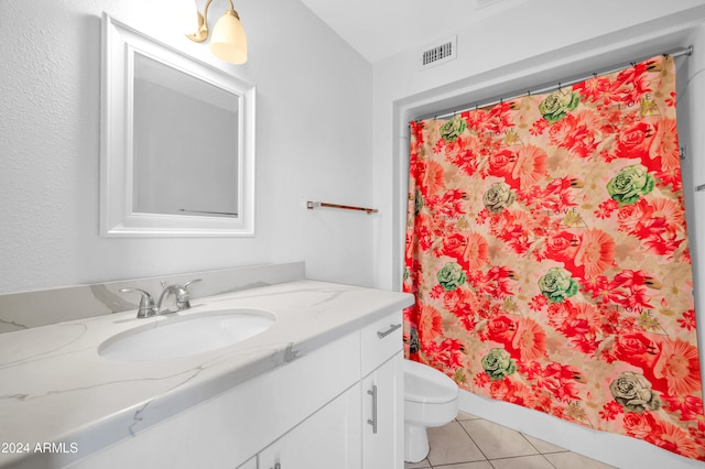 bathroom featuring vanity, curtained shower, tile patterned flooring, and toilet