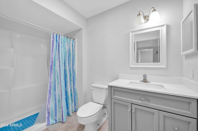 bathroom with walk in shower, vanity, toilet, and tile patterned floors