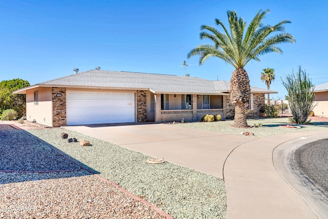 ranch-style home with a garage and covered porch