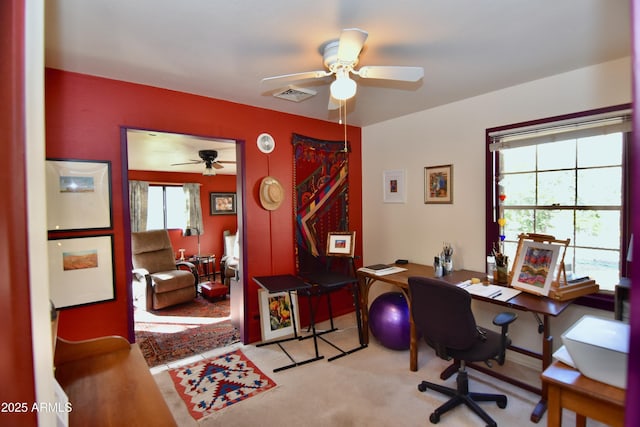 office area featuring light carpet and ceiling fan